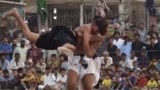 Wrestlers in action during a traditional Sindhi Malakhra wrestling event in Karachi, Pakistan. During a Malakhra match, both wrestlers tie twisted cloth around their opponents&#39; waists. They then grab the opponent&#39;s waist cloth and attempt to throw him to the ground.