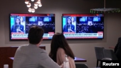 Viewers watch coverage of the shooting at a Washington gala where US President Donald Trump was attending on April 25.