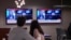 Viewers watch coverage of the shooting at a Washington gala where US President Donald Trump was attending on April 25.