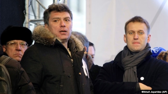 Boris Nemtsov (left) and Aleksei Navalny attend a rally to protest alleged vote-rigging in Russia's parliamentary elections in Moscow on December 24, 2011.