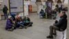 People take shelter inside a metro station during an air raid alert in Kyiv