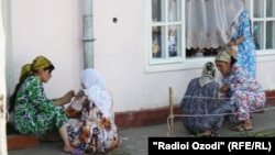 Women wait to see a fortune teller in Dushanbe.