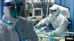 Doctors and nurses treating a COVID-19 case in a hospital in Tehran, Iran. March 11, 2020