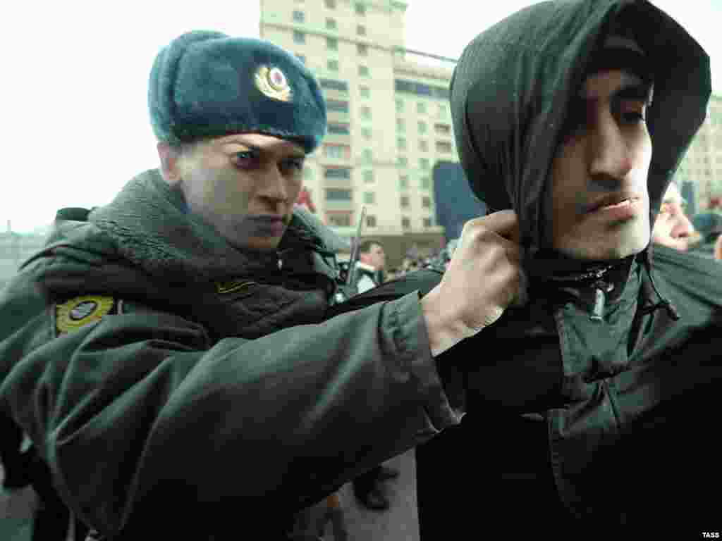 A Russian policeman detains a demonstrator after an authorized Day of Wrath protest in central Moscow on April 10. Photo by Vladimir Astapkovich for ITAR-TASS