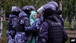 Police officers detain a demonstrator during a protest against the mobilization in Moscow on September 24.