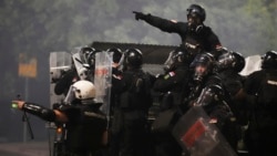 Serbian security forces at an anti-government protest near the Serbian Progressive Party office in Belgrade on August 15 