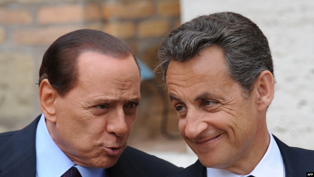 Italian Prime Minister Silvio Berlusconi (left) greets French President Nicolas Sarkozy prior to their summit in Rome.