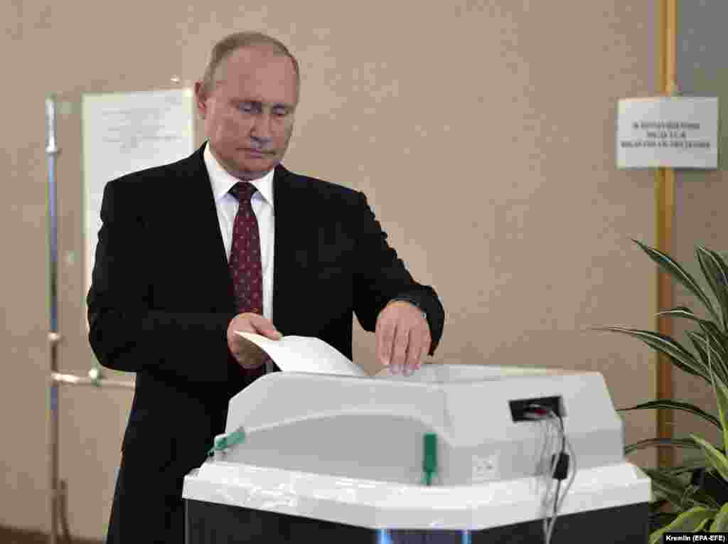 Russian President Vladimir Putin casts his vote at a polling station in Moscow.