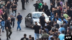 People react after a reported explosion occurred on September 18 during the funeral of those killed when hundreds of paging devices exploded across Lebanon the previous day.