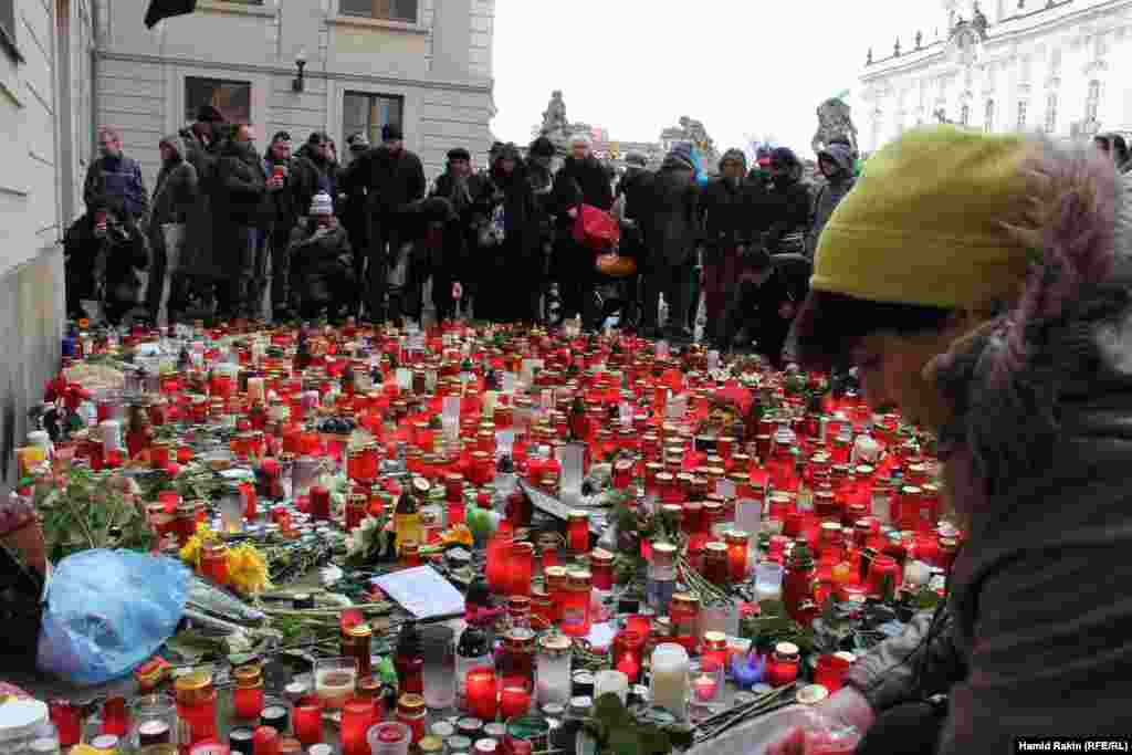 Mourners place candles outside Prague Castle as they await the arrival of the hearse carrying the late Czech President Vaclav Havel.