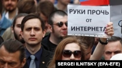 A woman holds a banner reading "Hands off the Internet" during a rally in Moscow in April.