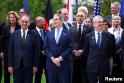 Ministers and other G7 attendees pose for a group photo in Paris on May 18.