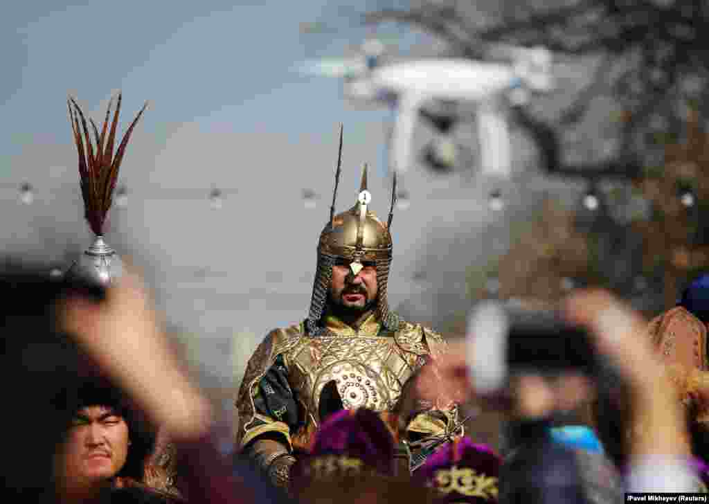 People take pictures as a reveler rides a horse during a parade as part of Norouz celebrations, an ancient holiday marking the spring equinox, in Almaty, Kazakhstan. (Reuters/Pavel Mikheyev)