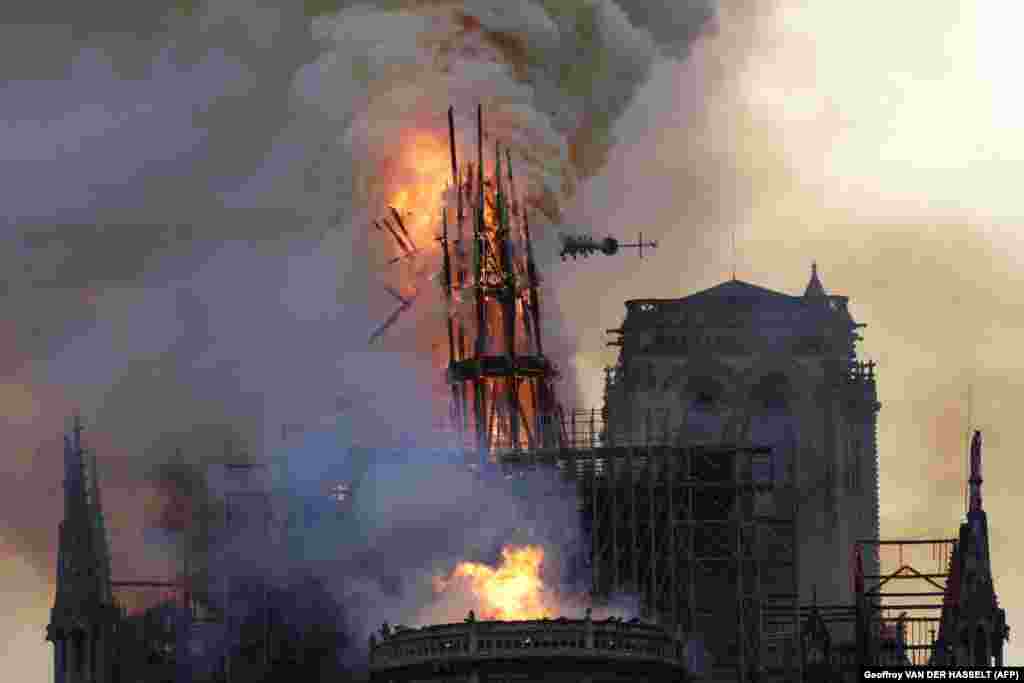 The steeple and spire collapses as smoke and flames engulf Notre Dame Cathedral in Paris on April 15. (AFP/Geoffroy Van der Hasselt)