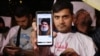 A man shows a photo of Hassan Nasrallah, secretary-general of Hezbollah, as people demonstrate against Israel and the attack on Lebanon in Tehran on September 28.