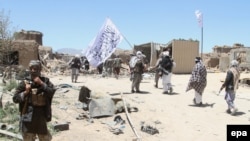 Suspected Taliban militants patrol after they reportedly took control of a rural district in Afghanistan's central Ghazni's province in May.