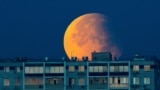 A partial lunar eclipse is seen over a residential building in Moscow.&nbsp;