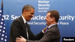 U.S. President Barack Obama (left) greets his Russian counterpart Dmitry Medvedev at a bilateral meeting before attending the 2012 Nuclear Security Summit in Seoul.