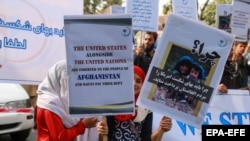 Afghans protest in Kabul on September 24 to demand that the United States unfreeze Afghan assets seized after the Taliban takeover.
