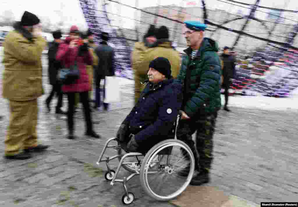 Veterans and other participants gather before a ceremony marking the 30th anniversary of the withdrawal of Soviet troops from Afghanistan at Victory Park, also known as Poklonnaya Gora War Memorial Park, in Moscow on February 15. (Reuters/Shamil Zhumatov)