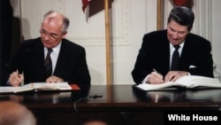 Soviet leader Mikhail Gorbachev (left) and U.S. President Ronald Reagan sign the INF Treaty in 1987.