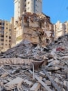 A person stands on the rubble of a damaged building after an Israeli strike on Beirut's southern suburbs, following renewed hostilities between Hezbollah and Israel amid the US-Israeli conflict with Iran, in Lebanon on March 5.