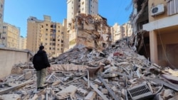 A person stands on the rubble of a damaged building after an Israeli strike on Beirut's southern suburbs, following renewed hostilities between Hezbollah and Israel amid the US-Israeli conflict with Iran, in Lebanon on March 5.