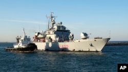 The Italian Navy ship Libra arrives at the port of Shengjin in northwestern Albania on October 16 carrying the first group of migrants who were intercepted in international waters and redirected to Albania as part of an agreement between the two countries.