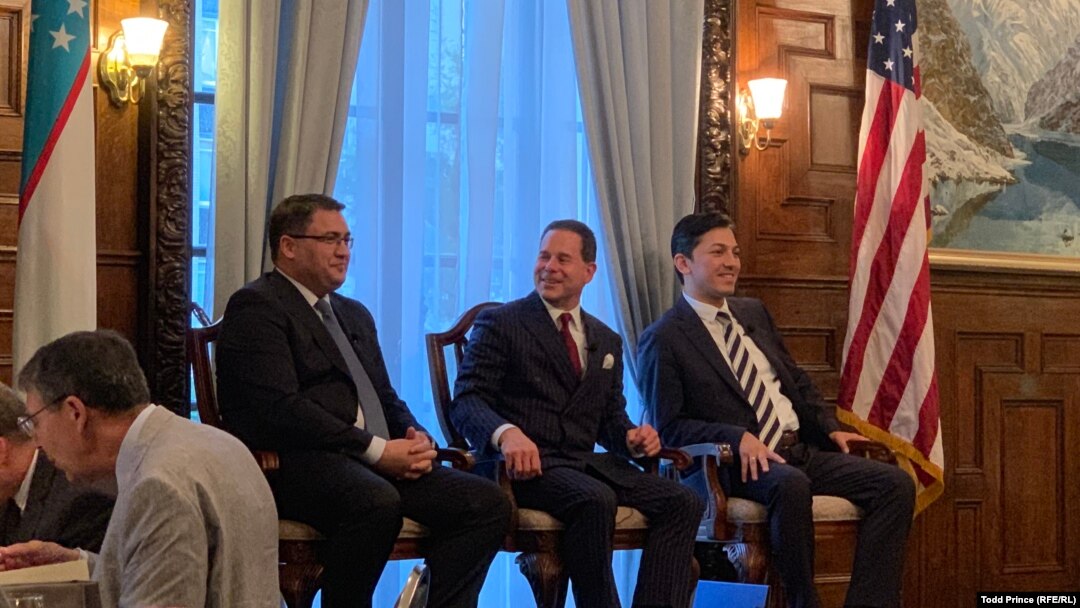 Uzbek Justice Minister Ruslanbek Davletov (left) and Capital Markets Development Agency Director Atabek Nazirov (right) speak to Baker McKenzie partner Thomas Firestone at the Uzbek Embassy in Washington on July 18. 