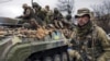 UKRAINE – A Ukrainian serviceman walks next to a fighting vehicle, outside Kyiv, April 2, 2022