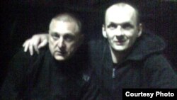 Mikalay Autukhovich (right) in a photo reportedly taken in prison in 2010