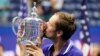 Russian tennis star Daniil Medvedev kisses the championship trophy after defeating Serbia's Novak Djokovic in the men's singles final of the U.S. Open on September 12, 2021, in New York City.