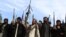 A pro-government anti IS volunteers brandish their weapons in eastern Afghanistan.
