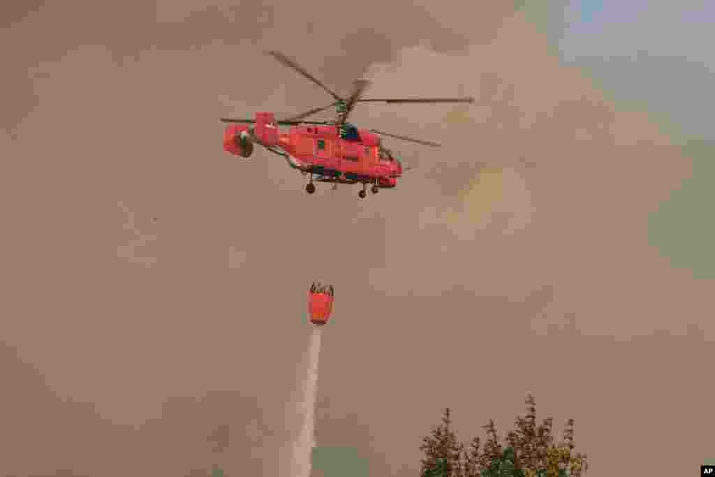 Helikopter srpske vatrogasne službe gasi požar sjeveroistočno od glavnog grada Crne Gore, Podgorice, 12. augusta 2025.