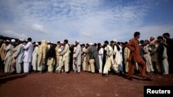 FILE: Internally displaced men from tribal areas line-up to be registered by aid agencies.