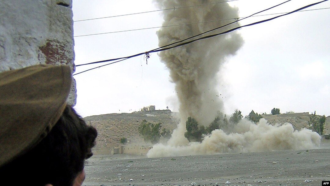 A tribesman watches a strike on an alleged militant hideout in Miranshah (file photo)