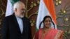 Indian Foreign Minister Sushma Swaraj (right) poses for photos with Iranian Foreign Minister Mohammad Javad Zarif prior to a meeting in New Delhi on May 14. 