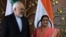 Indian Foreign Minister Sushma Swaraj (right) poses for photos with Iranian Foreign Minister Mohammad Javad Zarif prior to a meeting in New Delhi on May 14. 