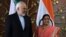 Indian Foreign Minister Sushma Swaraj (right) poses for photos with Iranian Foreign Minister Mohammad Javad Zarif prior to a meeting in New Delhi on May 14. 