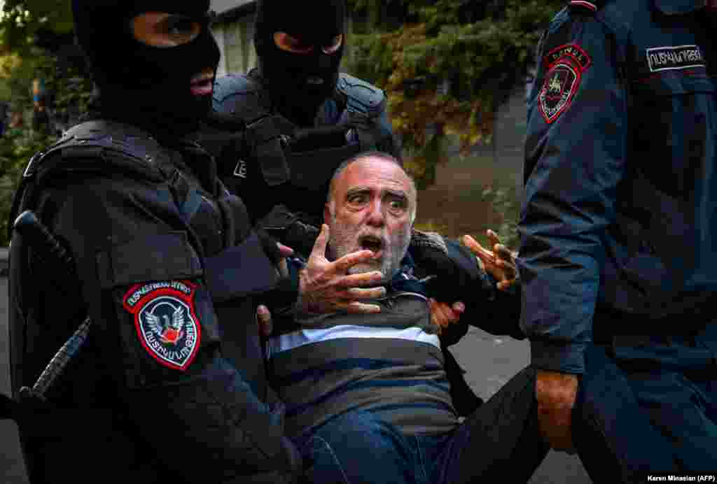 Armenian police officers detain a protester during a rally against the country&#39;s agreement to end fighting with Azerbaijan over the breakaway Nagorno-Karabakh region in Yerevan on November 12. (AFP/Karen Minasian)​