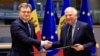 Moldovan Prime Minister Dorin Recean (left) shakes hands with European Union foreign policy chief Josep Borrell after a signing ceremony in Brussels on May 21.
