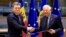 Moldovan Prime Minister Dorin Recean (left) shakes hands with European Union foreign policy chief Josep Borrell after a signing ceremony in Brussels on May 21.