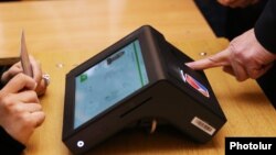 Armenia - An electronic authentication device takes a voter's fingerprints at a polling station in Yerevan, 2 April, 2017 