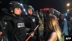 U.S. -- Police gather around protestors following the fatal police shooting of a black man, with a dozen officers and several demonstrators injured in the violence on September 20, 2016 in Charlotte, North Carolina. Media reported that several hundred peo