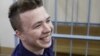 BELARUS - Opposition blogger and activist Roman Protasevich, who is accused of participating in an unsanctioned protest at the Kuropaty preserve, smiles as he waits before the beginning of a court hearing in Minsk, Belarus April 10, 2017