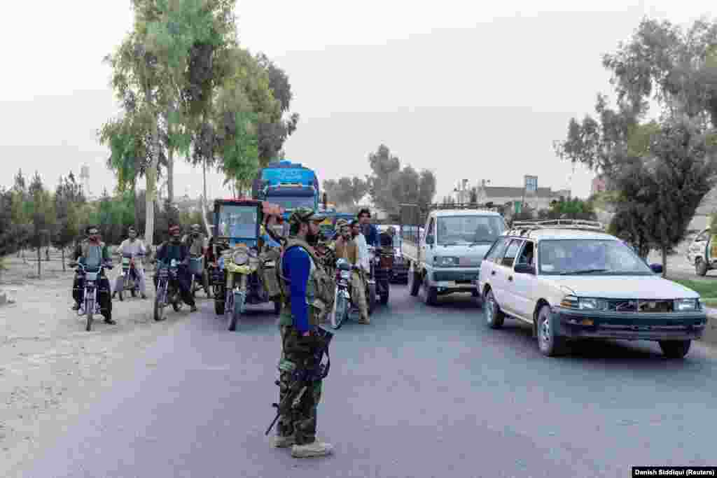 A special forces soldier stops traffic near the site where the convoy came under attack.&nbsp;Shah told Reuters after being rescued: &quot;We were 15 [police] and all my comrades surrendered [to the Taliban] except me...I said to myself that I&#39;m not going to do that and, as long as I have a gun, why should I give up?&quot;