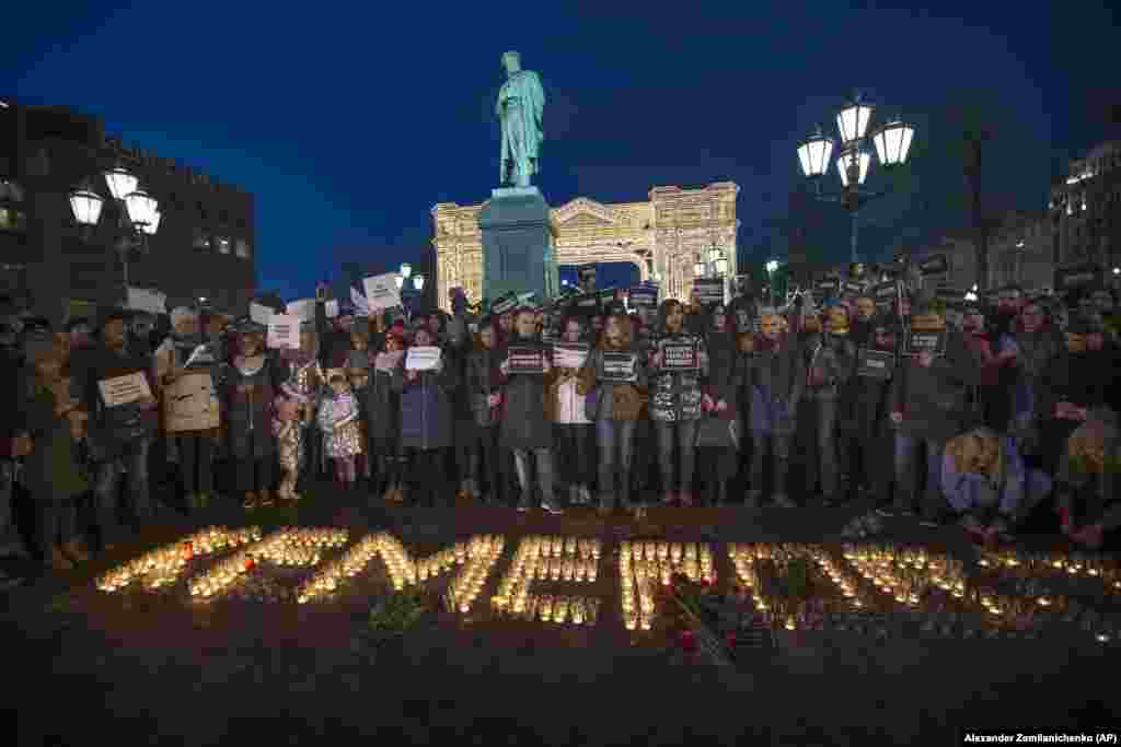 People stand in front of the word &quot;Kemerovo,&quot; made up of candles, to commemorate the victims of the March 25 fire in a shopping mall in the Siberian city of Kemerovo, in Moscow&#39;s Pushkin Square, on March 27. (AP/Aleksandr Zemlianichenko)