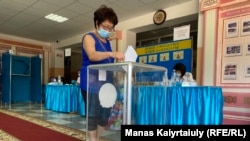 A woman votes in the local election in the Almaty region on July 25.