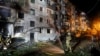 Firefighters work at the site of an apartment building hit by a Russian missile strike in Kyiv on August 1.