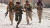 Syrian Kurdish fighters from the People's Protection Units (YPG) run across a street in Raqqa on July 3.